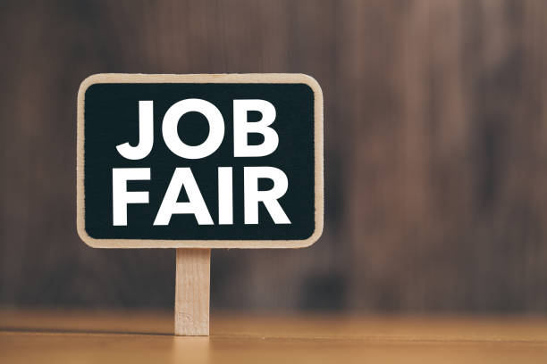 Job Fair text on blackboard sign board against wooden background.